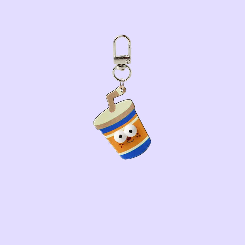 A cute cartoon coffee cup keychain charm with a smiling face