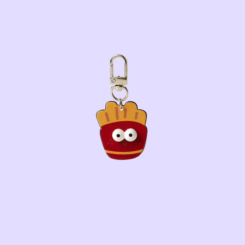 A small charm shaped like a red french fries bucket with a yellow top, cartoon eyes, and a silver clasp