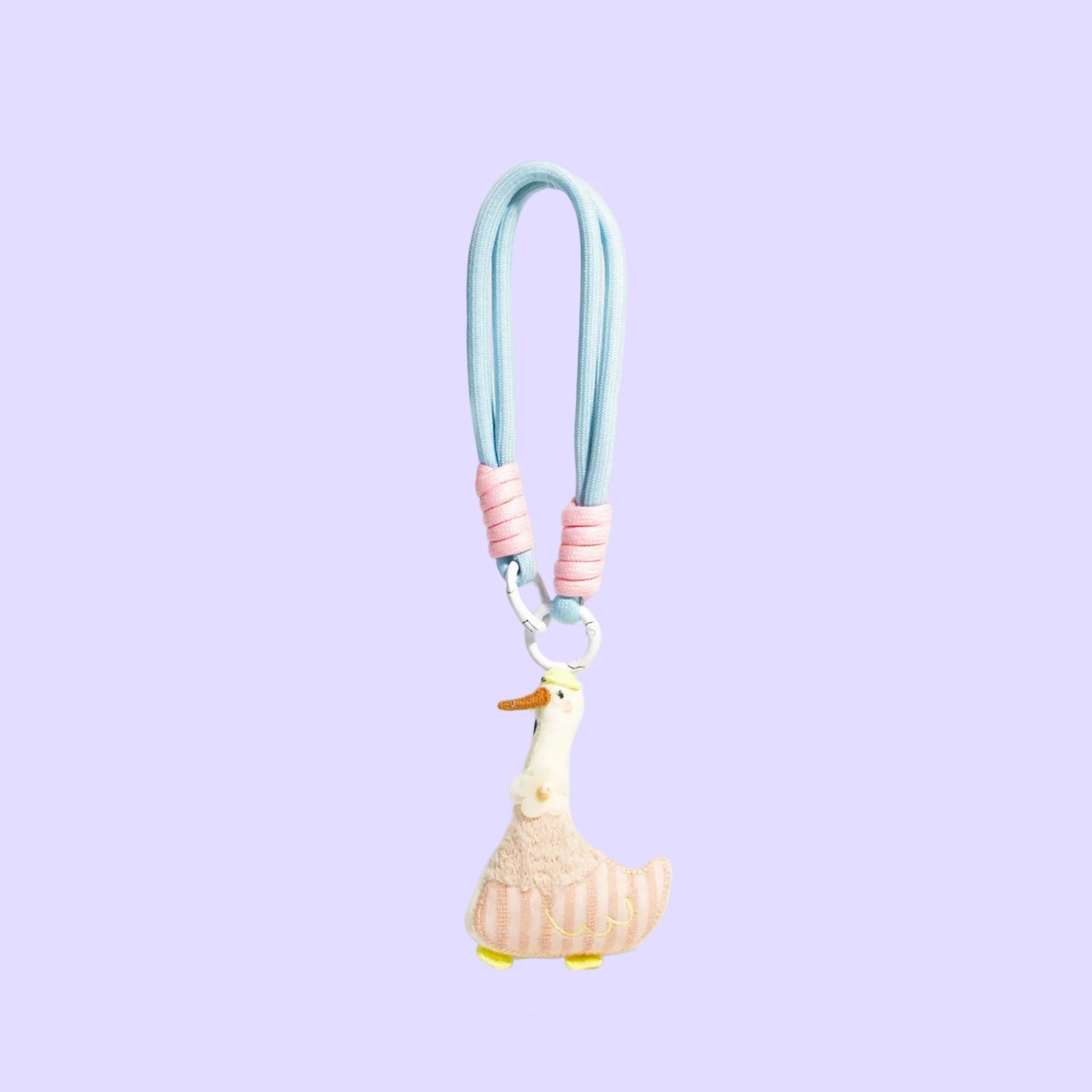 A pastel-colored duck charm keychain or bag clip with a light blue strap, pink ribbed accents, and a cream duck figure with yellow feet