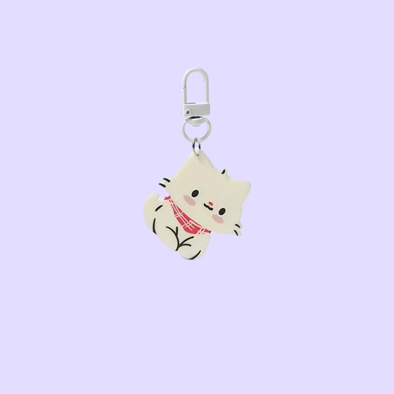 A cute cartoon cat keychain charm with a silver carabiner clip, featuring a cream-colored cat wearing a red plaid scarf